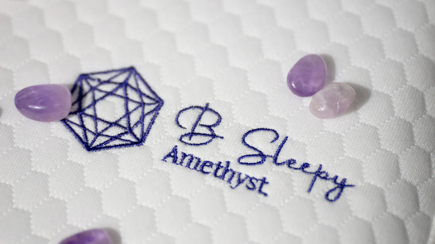 Close-up of the embroidered B Sleepy Amethyst logo with crystals